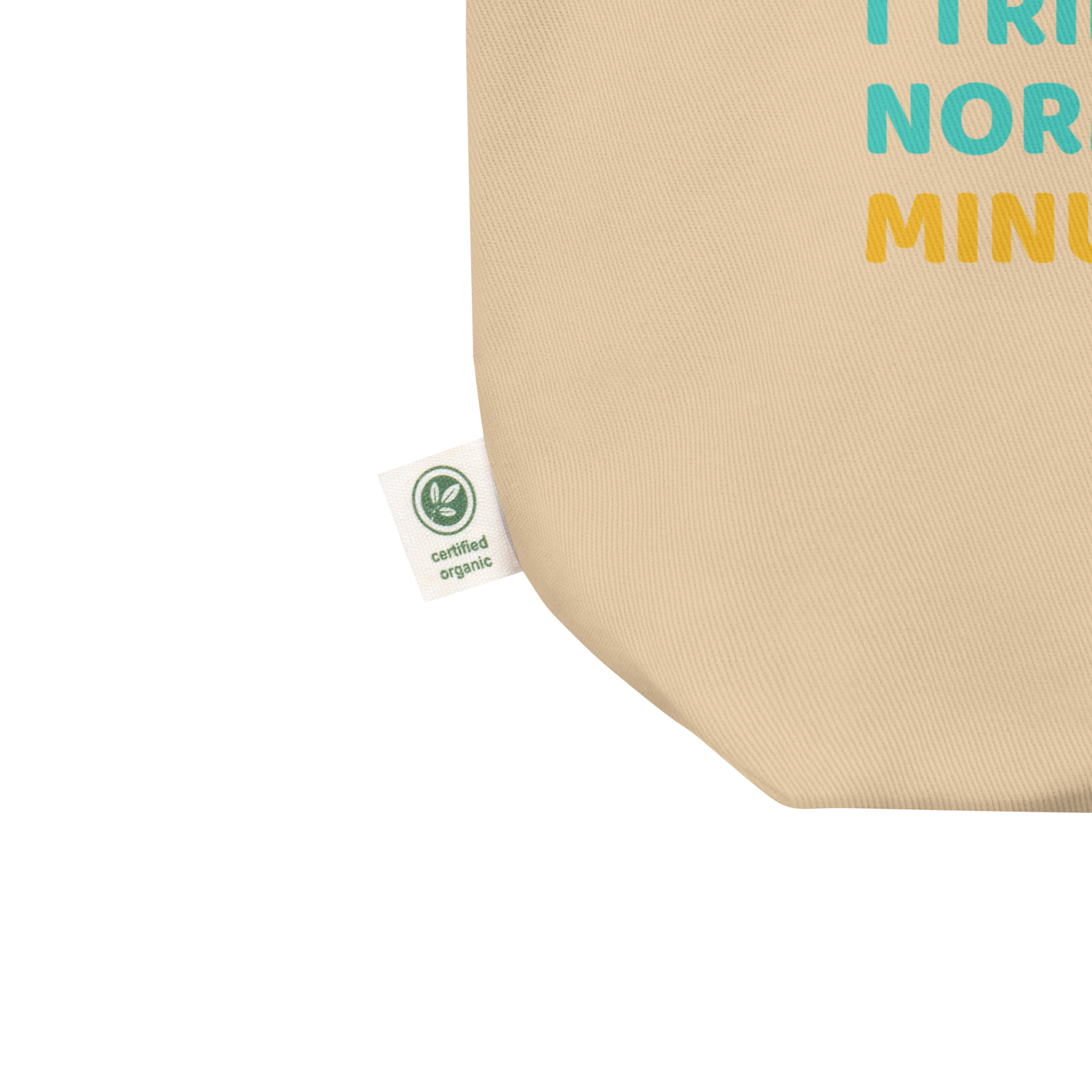 Close-up of beige organic cotton tote bag by Pepa de Mango, showing certified organic label tag and eco-friendly stitching detail, sustainable fashion accessory