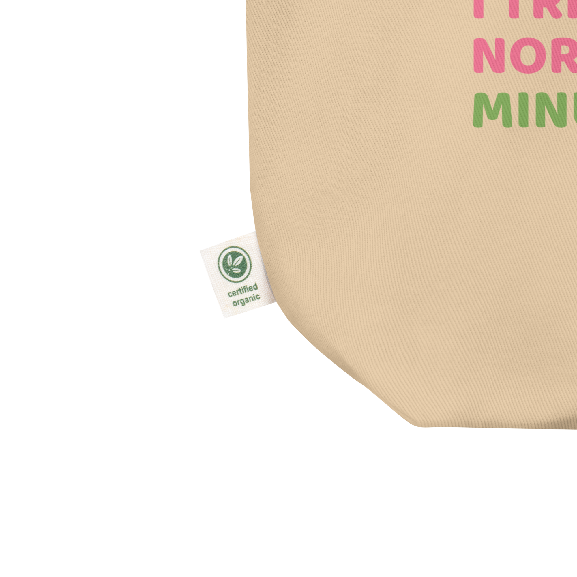 Close-up of beige organic cotton tote bag by Pepa de Mango, showing certified organic label tag and eco-friendly stitching detail, sustainable fashion accessory