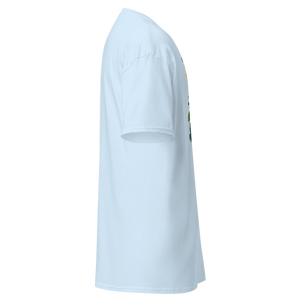 Right side view of a light blue unisex statement t-shirt by Pepa de Mango. The shirt’s soft cotton texture is visible along the sleeve and side seam. A small portion of the front design is slightly visible, featuring vibrant tropical leaves and part of a retro illustration. The main print includes the quote "COMMON SENSE IS SO RARE IT SHOULD BE CLASSIFIED AS A SUPERPOWER". Displayed on a transparent background.