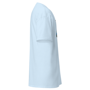 Right side view of a light blue unisex statement t-shirt by Pepa de Mango, featuring a soft cotton texture, short sleeves, and relaxed silhouette. Partial view of the tropical print with a clown face, exotic leaves, and the beginning of a sarcastic phrase in pink and yellow. Shown against a transparent background.