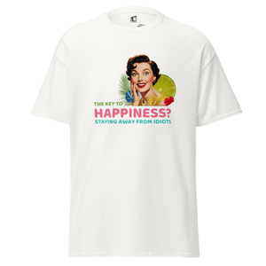 Front view of a white unisex statement t-shirt by Pepa de Mango, featuring the phrase “The key to happiness? Staying away from idiots” in bold text with a retro collage of a smiling woman, lime, and tropical florals.