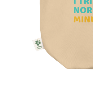 Close-up of beige organic cotton tote bag by Pepa de Mango, showing certified organic label tag and eco-friendly stitching detail, sustainable fashion accessory