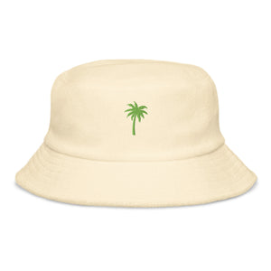 Front view of yellow organic cotton bucket hat by Pepa de Mango with green palm tree embroidery, unisex summer fashion accessory